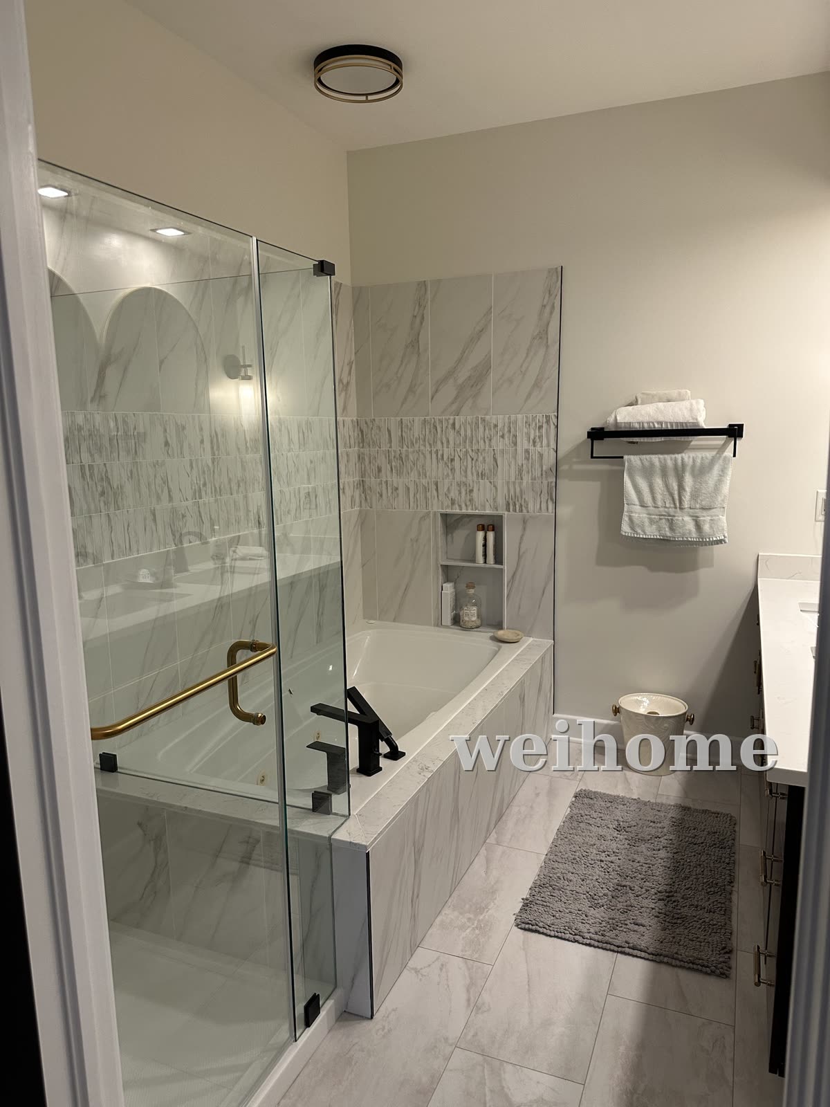 Ensuite with glass shower and tiled tub