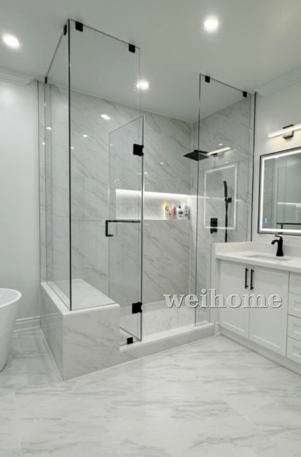 Frameless glass shower with matte black hardware and tiled bench